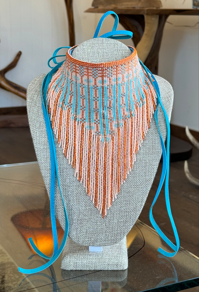 Orange and light blue beaded bandanna on form