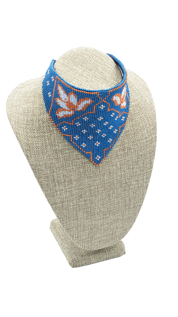 Blue, orange, and white seed beads with white vinyl backing. Finished with blue deer skin cord.