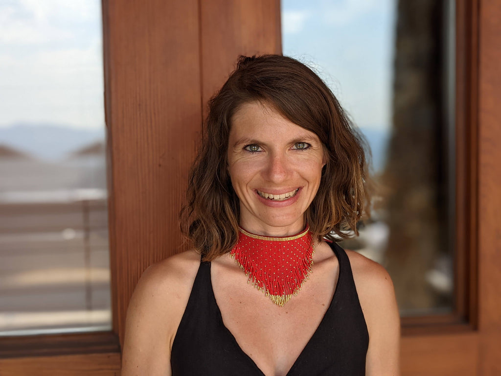 Woman wearing red and gold beaded bandana