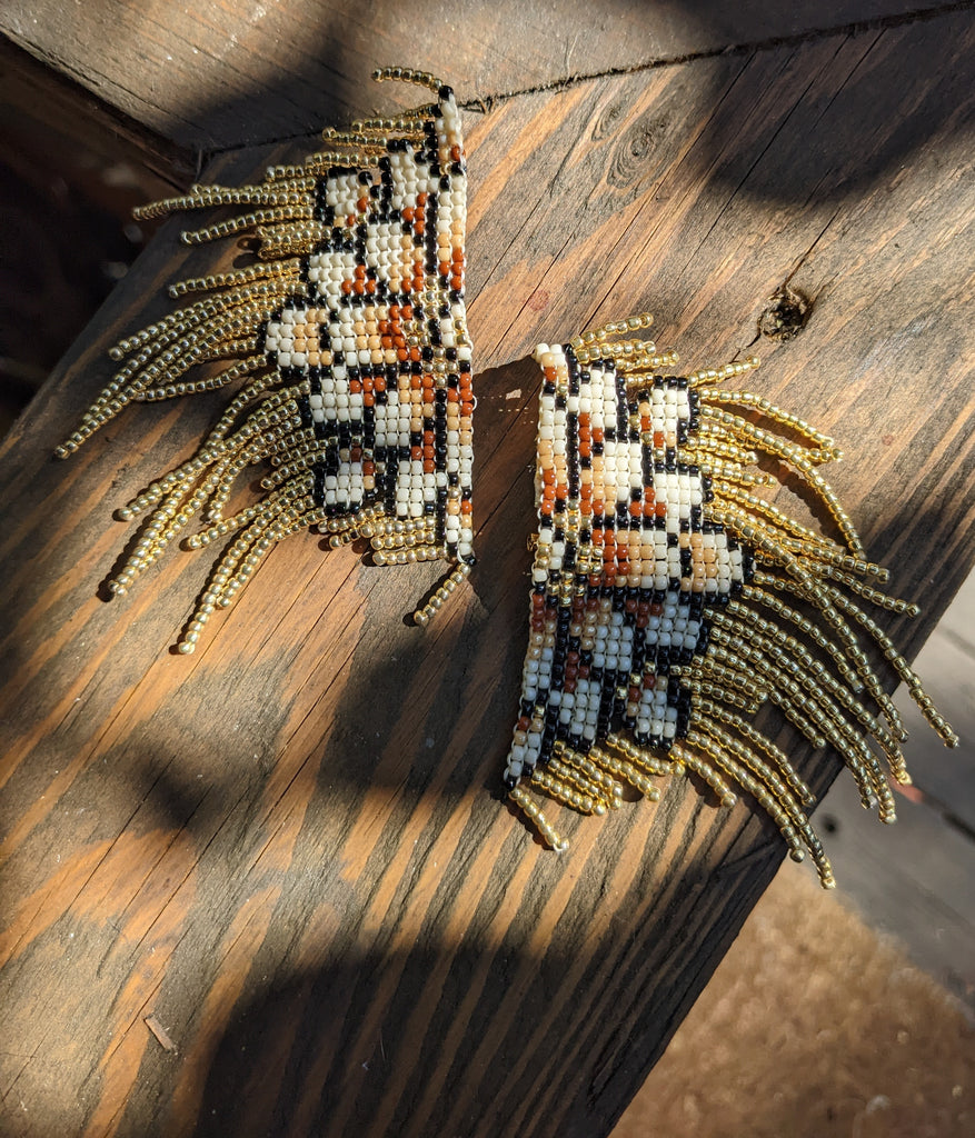 Cream, tan, terra cotta and gold ombre flower earrings to celebrate the change of season, here in the Tetons. Finished with a post and clip and hand stitched vegan leather in the back. 3 inches long, 3 inches wide to end of fringe